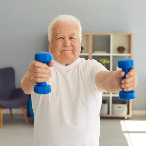 Older man exercising with dumbbells